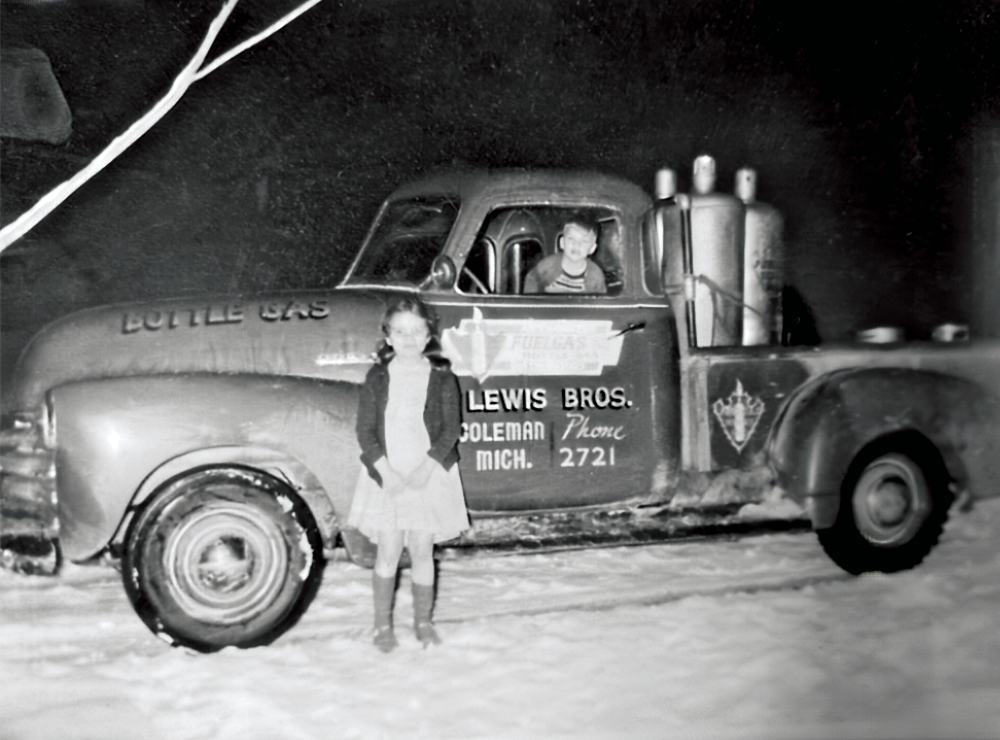 Vintage Lewis Bros bottle gas truck from Coleman, Michigan, parked in the snow
